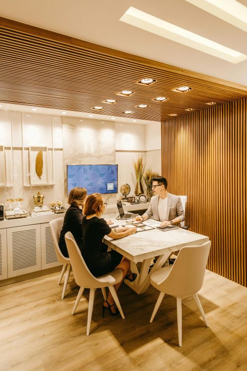 A group of professionals engaging in a meeting within a stylish office setting, fostering teamwork and cooperation.